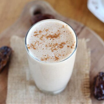 Tahini date smoothie in a small glass.