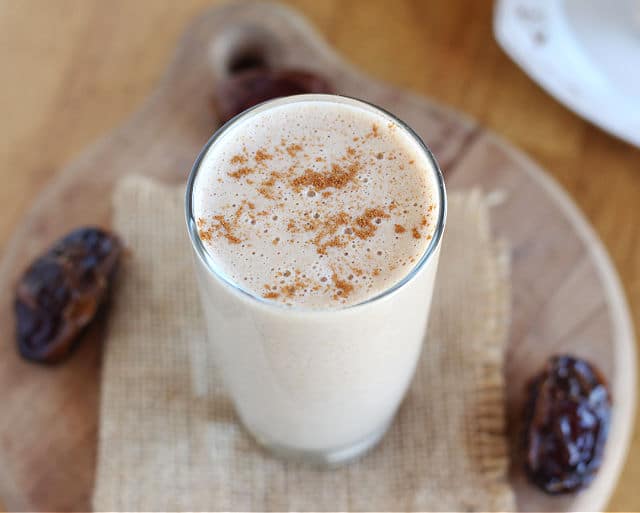 Tahini date smoothie in a small glass.