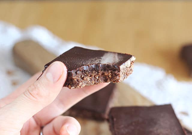 Bite of raw brownies with healthy frosting 