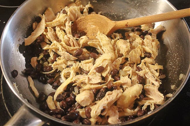 Chicken and beans in a pan.