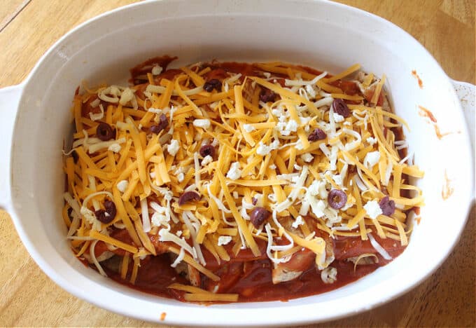 Unbaked enchiladas in a baking dish.