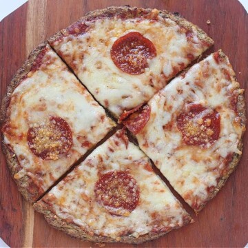 Zucchini pizza cut into four pieces.