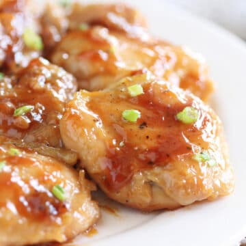 Close-up of a plateful of chicken with a thick, syrupy sauce.