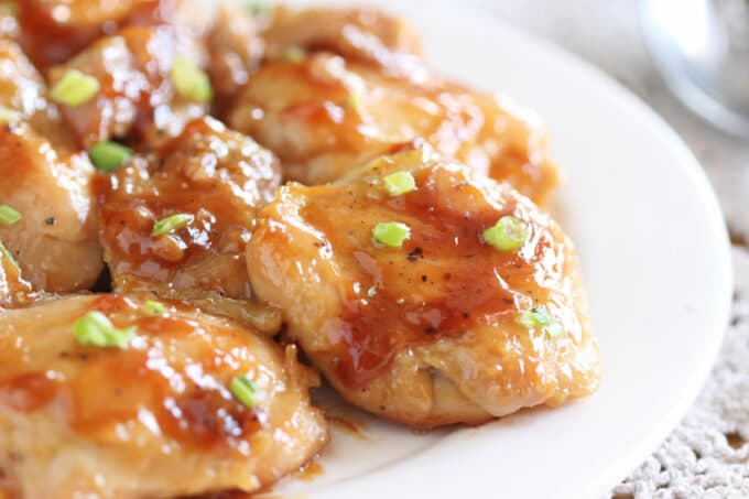 Close-up of a plateful of chicken with a thick, syrupy sauce.