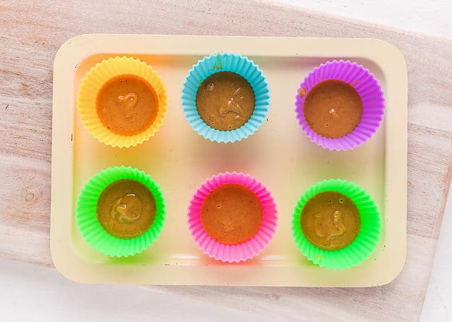 Making homemade peanut butter cups in silicone muffin holders.
