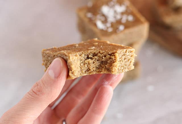 Hand holding a healthy almond butter bar.