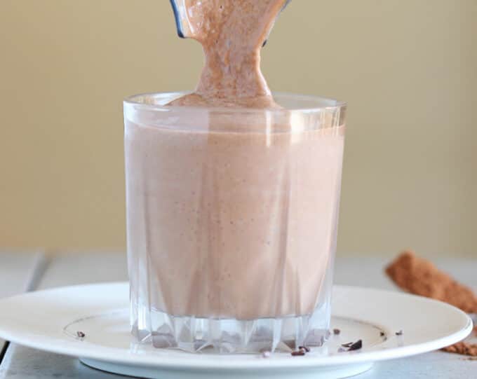 Chocolate smoothie being poured into a glass.