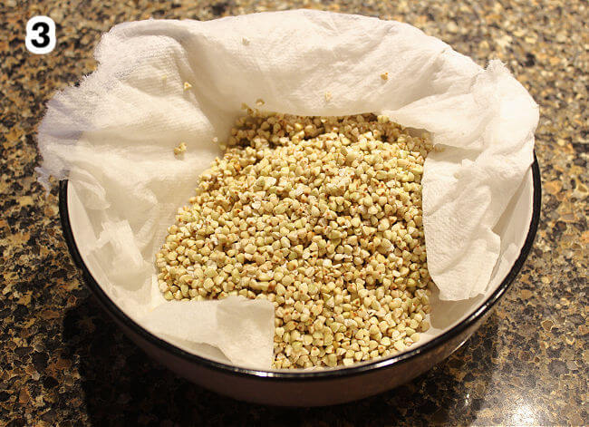 Patting buckwheat groats dry.