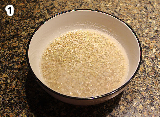 Raw buckwheat groats soaking in a bowl.