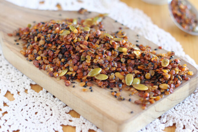 Granola spread on a wood board.