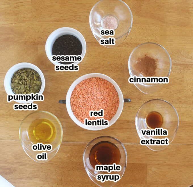 Various ingredients laid out on a table, including red lentils and maple syrup.
