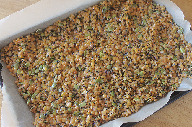 Lentils spread out on a baking sheet.