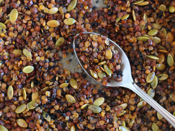 Spoonful of granola on a baking sheet.