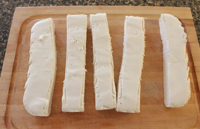 Cutting homemade marshmallows into squares.