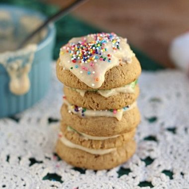 Four cookies on a table covered in healthy frosting.