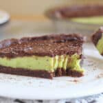 Forkful of pie with chocolate and mint layers.