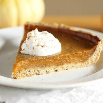 Slice of pumpkin pie with whipped cream.