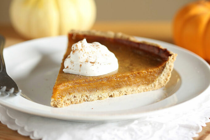 Slice of pumpkin pie with whipped cream.