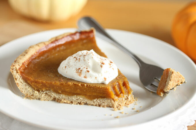 Slice of pumpkin pie with a fork.