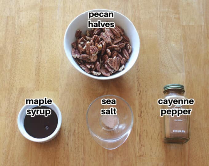 Ingredients for maple pecans laid out on a wood table.