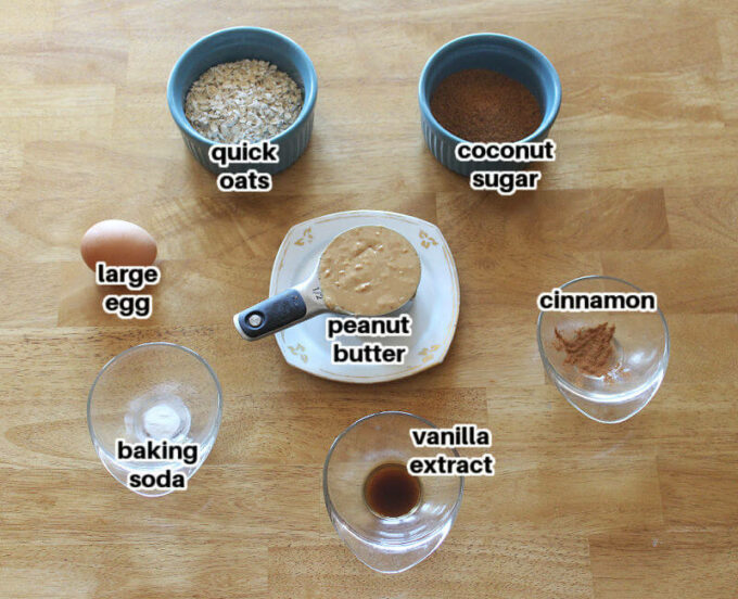 Peanut butter and other ingredients for cookies laid out on a wooden table.