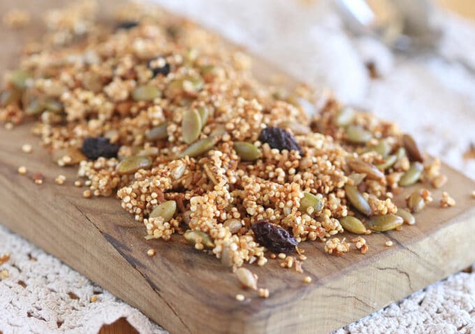 Quinoa granola on a wood cutting board.