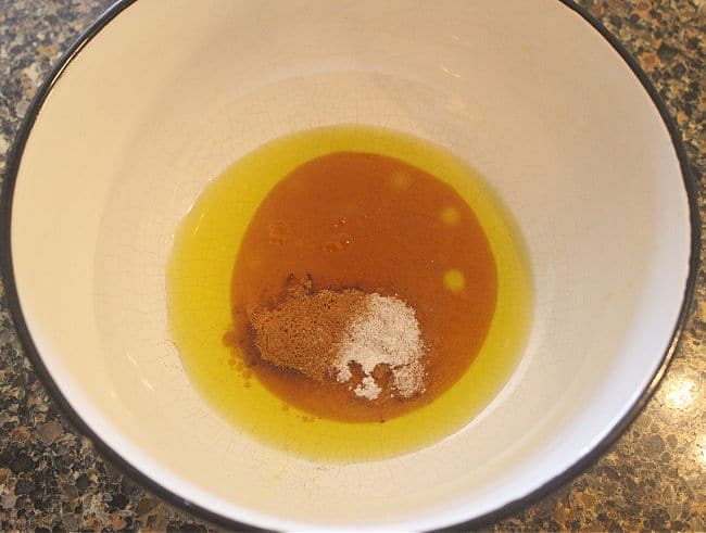 Oil, cinnamon, salt, and maple syrup in a bowl.