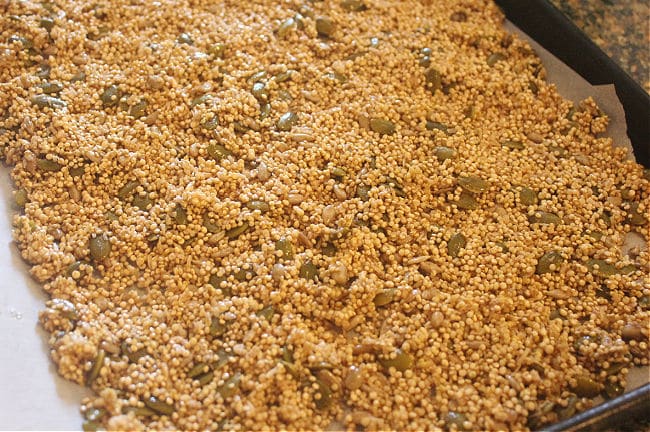 Unbaked quinoa granola on a baking sheet.