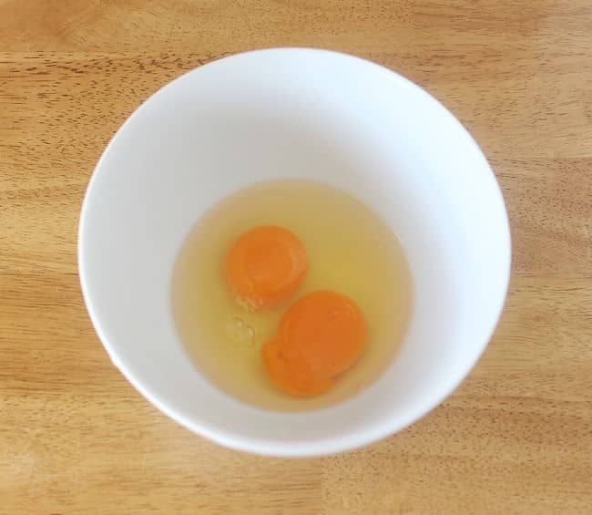 Two eggs in a white bowl.