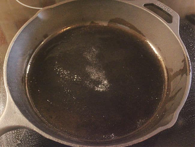 Cast iron frying pan with melted butter.