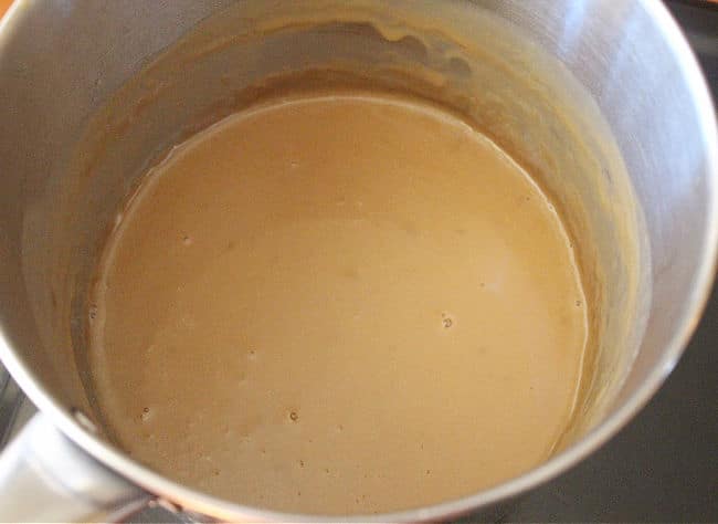 Thick coconut milk in a saucepan.