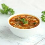Cabbage soup with tomatoes and vegetables in a bowl