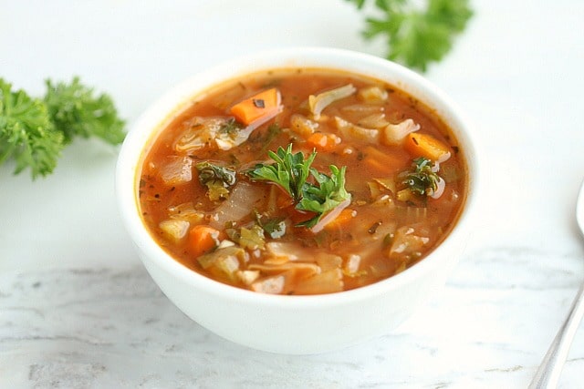 Spicy cabbage soup in a white bowl