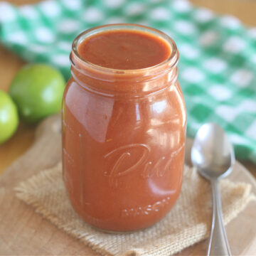 Side view of a glass jar of enchilada sauce.