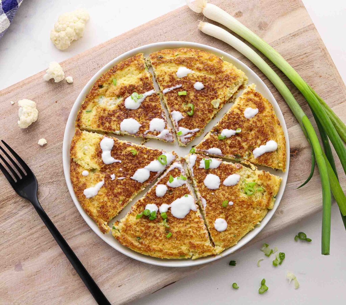 Cauliflower pancake slices on a plate.