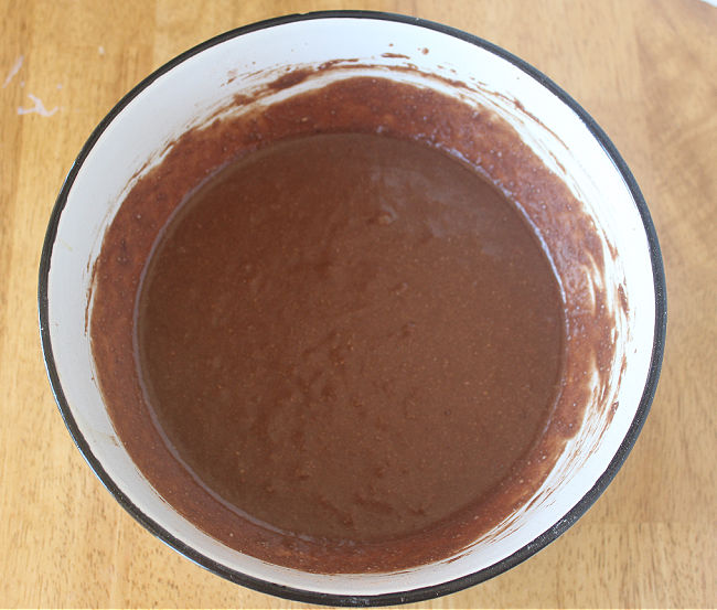 Brownie batter in a large white bowl.
