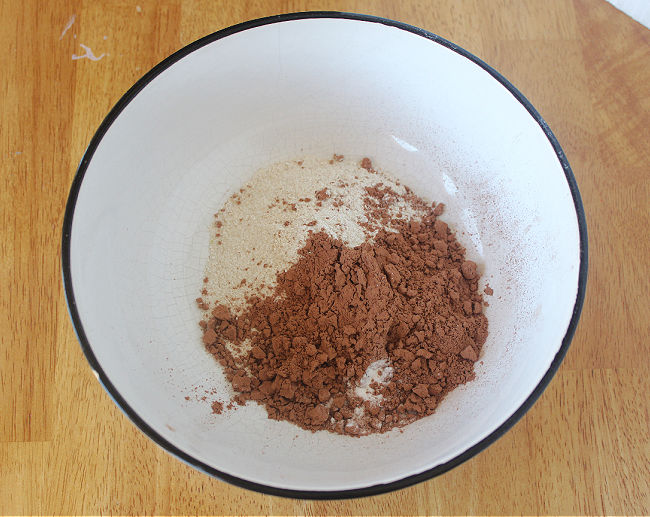 Flour and cocoa powder in a large white bowl.