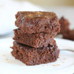 Stack of three chocolate brownies.