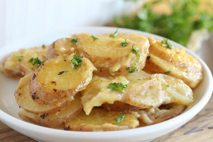 Close-up of potato casserole on a white plate.