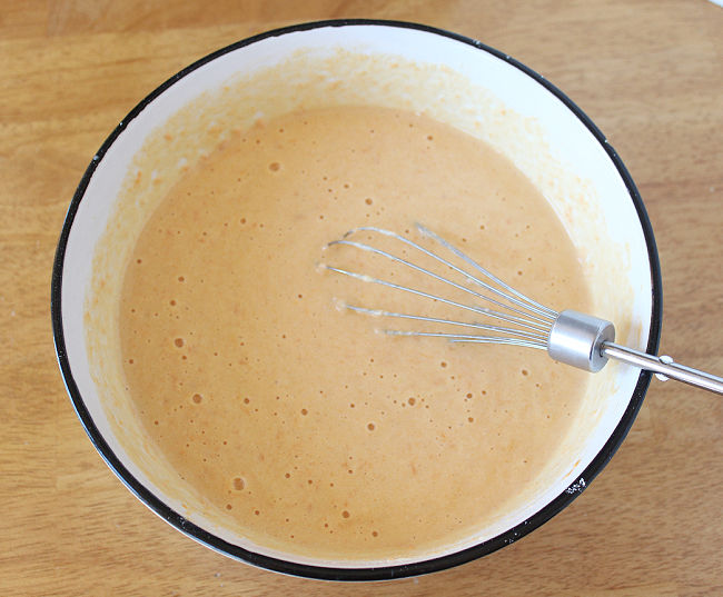 Cornbread batter in a white bowl.