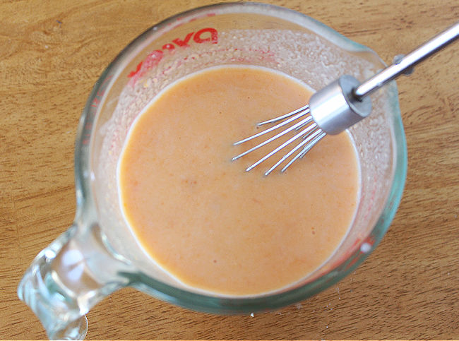 Buttermilk and sweet potato in a glass pint pitcher.