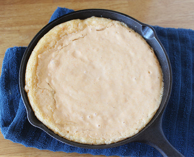 Unbaked cornbread in a cast iron skillet.
