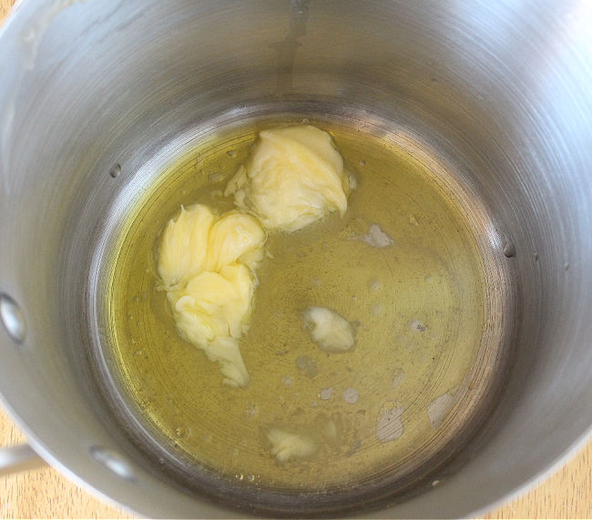 Olive oil and butter melting in a saucepan.