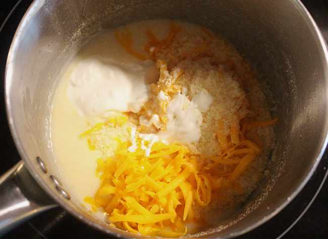Roux with yogurt and cheese being mixed in.