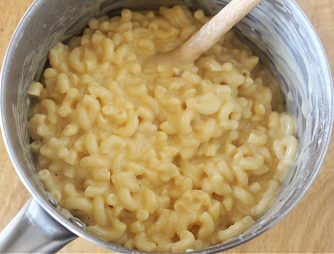 Mac and cheese in a steel saucepan.