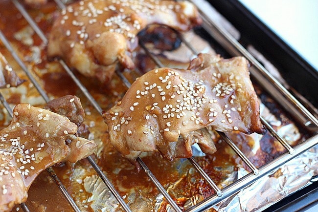 Teriyaki chicken thighs on a baking rack.