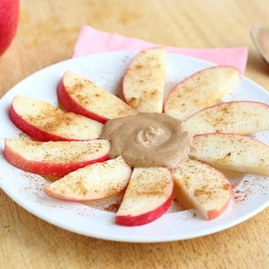 Peanut butter and apples on a plate