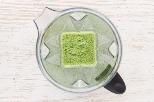 Spinach blended with water in a blender.