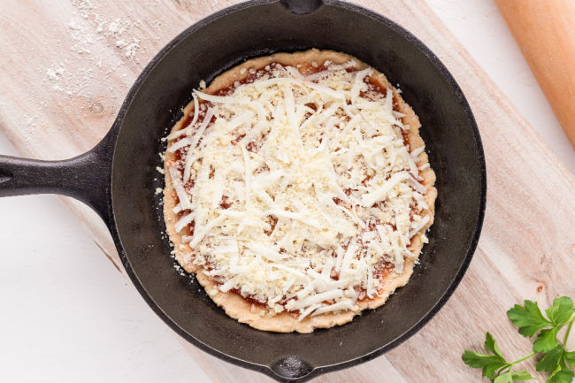 Cheese on an unbaked pizza.