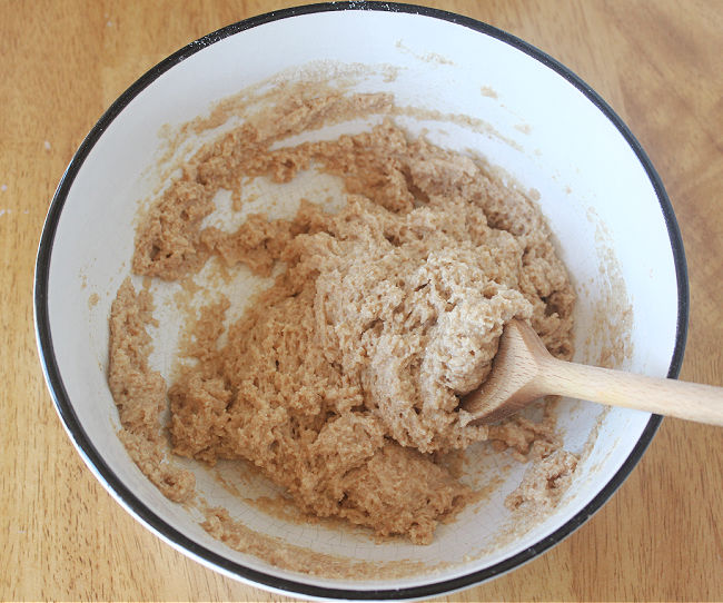 Mixing dough in a white bowl.